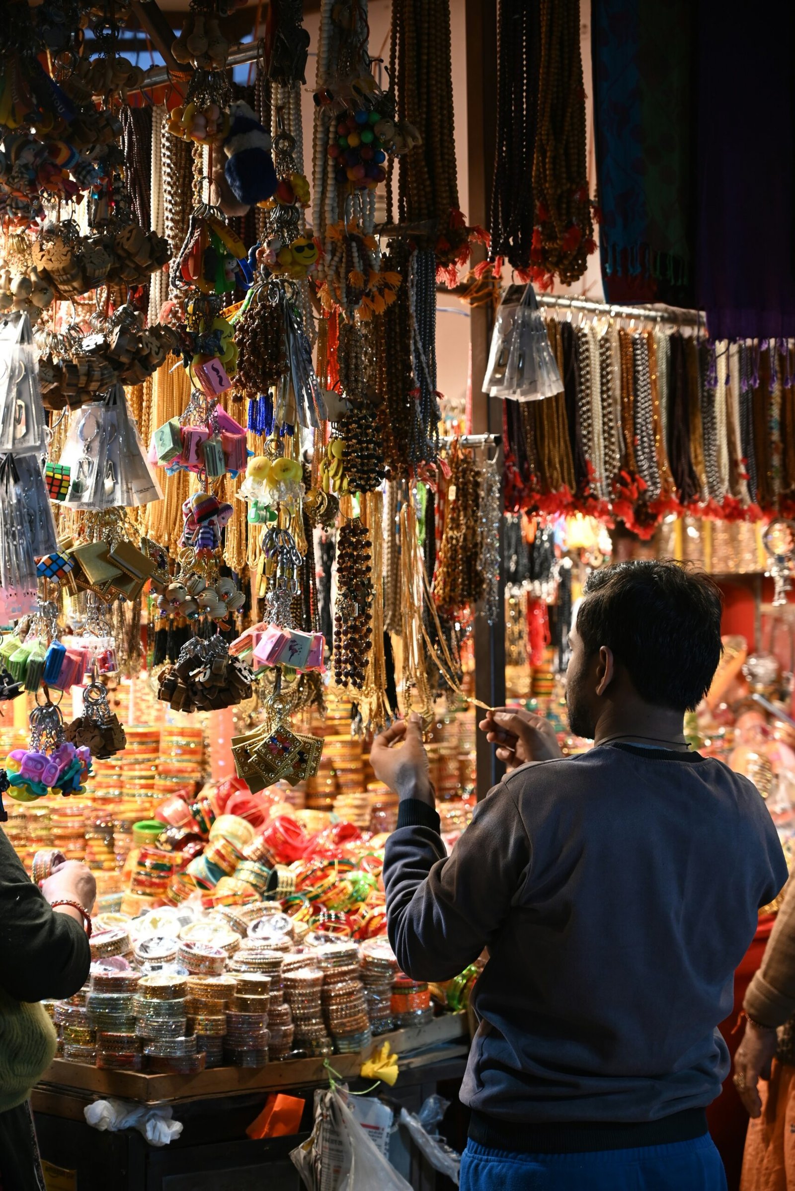 a man standing in front of a store filled with jewelry